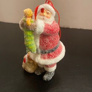 Santa Claus holding Christmas stocking resin glass glitter figurine ornament 5”